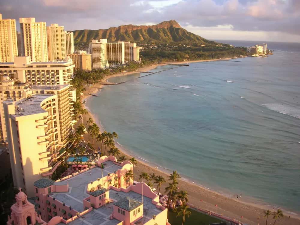Waikiki Beach curving towards Diamond Head at sunset.