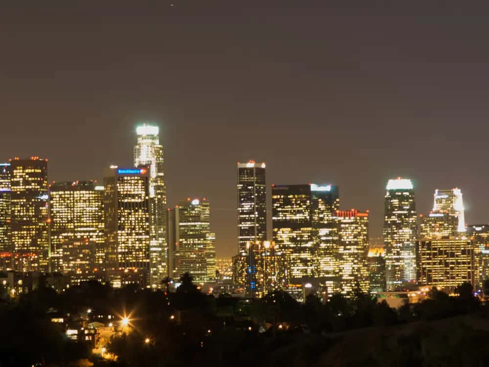 Downtown Los Angeles skyline lit up at night.